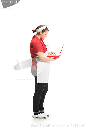 Image of Portrait of cute smiling woman with laptop in her hands in the studio, isolated on white background