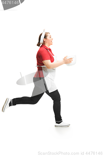 Image of Portrait of cute smiling woman with bowl in her hands in the studio, isolated on white background