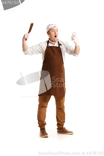 Image of Smiling butcher posing with a cleaver isolated on white background