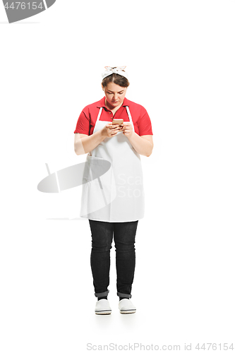 Image of Portrait of cute woman with mobile phone in her hands in the studio, isolated on white background