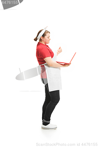 Image of Portrait of cute smiling woman with laptop in her hands in the studio, isolated on white background