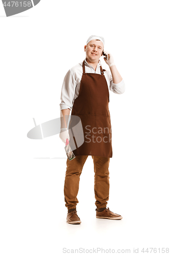 Image of Smiling butcher posing with a cleaver isolated on white background