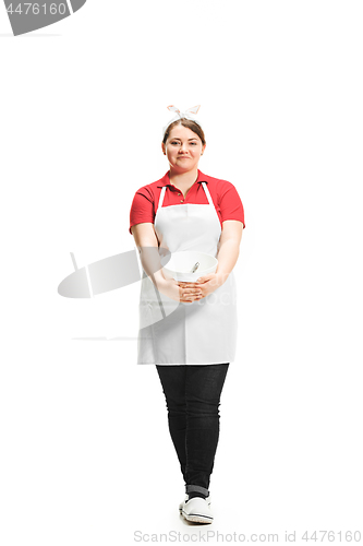 Image of Portrait of cute smiling woman with bowl in her hands in the studio, isolated on white background