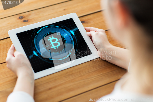 Image of hands with bitcoin on tablet pc computer screen