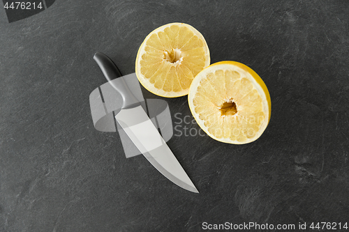 Image of close up of chopped lemon and knife on table