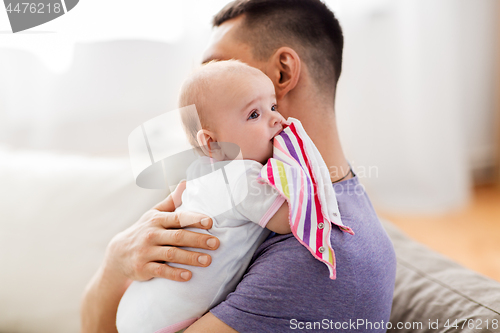 Image of father with little baby girl at home