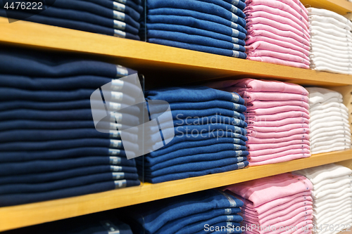 Image of close up of shelves with clothes at clothing store