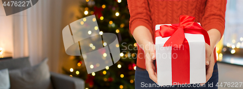 Image of close up of woman hands holding christmas gift