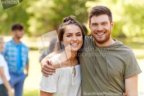 Image of happy couple hugging at summer park
