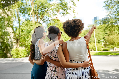 Image of young women or friends hugging at summer park