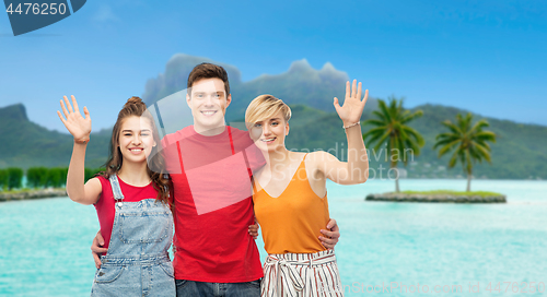 Image of happy friends hugging over bora bora beach