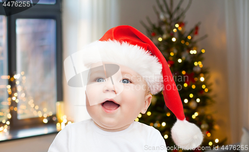 Image of close up of little baby in santa hat on christmas