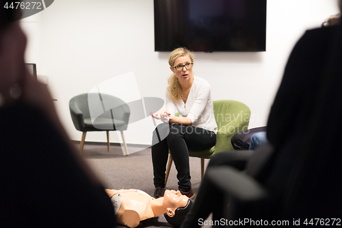 Image of Instructor teaching first aid cardiopulmonary resuscitation course and use of automated external defibrillator on CPR workshop.