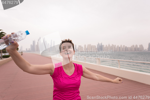 Image of young woman celebrating a successful training run