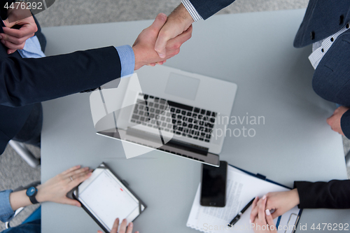 Image of cloasing the deal in modern office interior top view