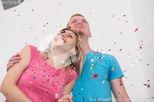 Image of romantic young  couple celebrating  party with confetti