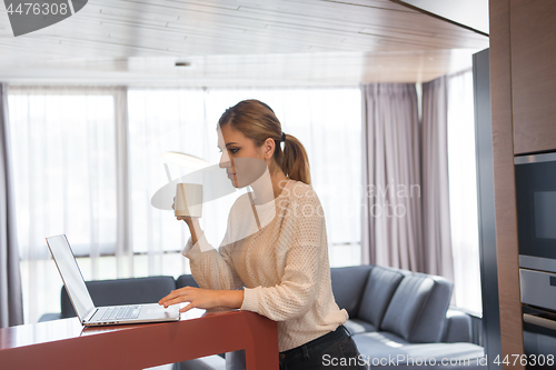 Image of woman drinking coffee enjoying relaxing lifestyle