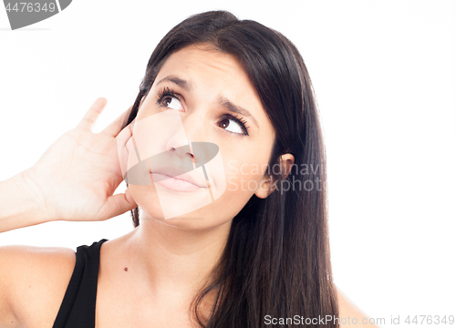 Image of Young woman trying to listen something