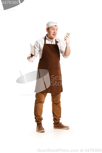 Image of Smiling butcher posing with a cleaver isolated on white background