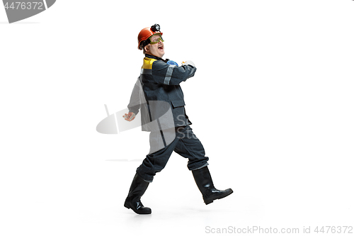 Image of The studio shot of senior bearded male miner standing at the camera on a white background.