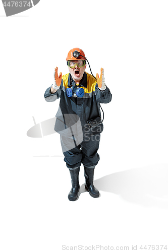 Image of The studio shot of senior bearded male miner standing at the camera on a white background.