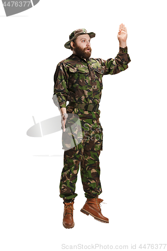 Image of Young army soldier wearing camouflage uniform isolated on white