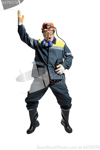 Image of The studio shot of senior bearded male miner standing at the camera on a white background.