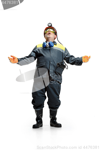 Image of The studio shot of senior bearded male miner standing at the camera on a white background.