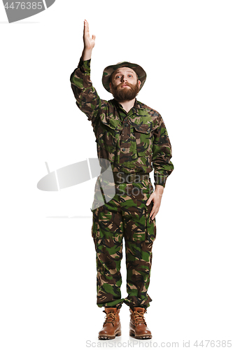 Image of Young army soldier wearing camouflage uniform isolated on white