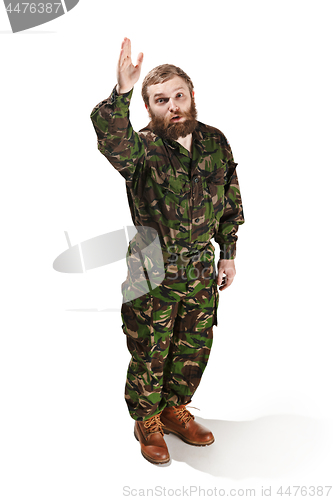 Image of Young army soldier wearing camouflage uniform isolated on white