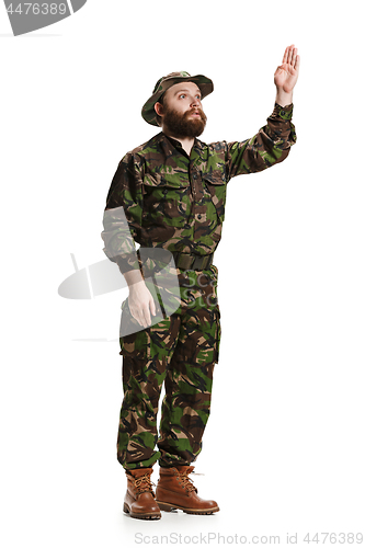 Image of Young army soldier wearing camouflage uniform isolated on white