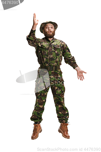 Image of Young army soldier wearing camouflage uniform isolated on white