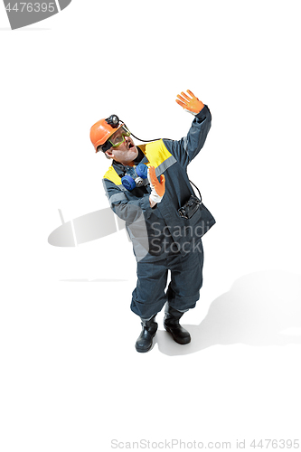 Image of The studio shot of senior bearded male miner standing at the camera on a white background.