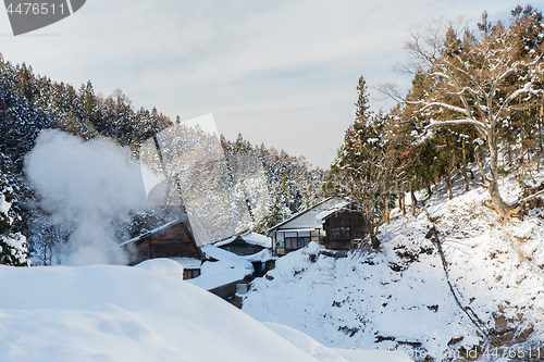 Image of country houses and forest hills in winter, japan