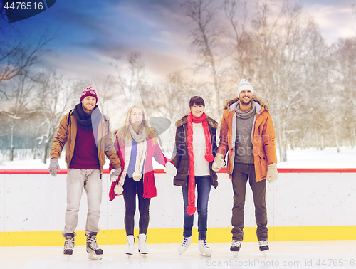 Image of happy friends on outdoor skating rink