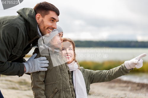 Image of happy family on autumn beach