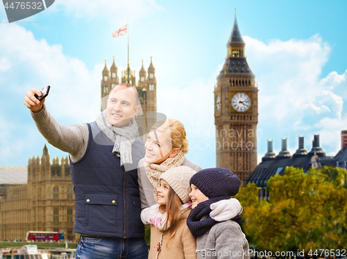 Image of family taking selfie by smartphone in london city