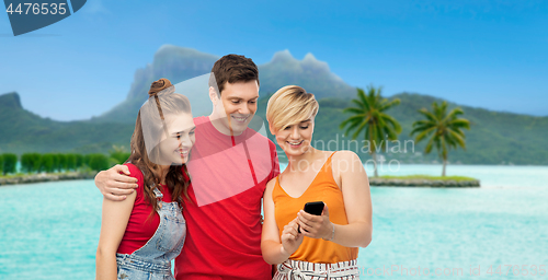 Image of friends with smartphone over bora bora beach