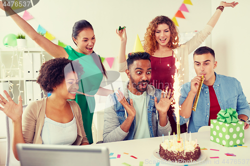 Image of office team greeting colleague at birthday party