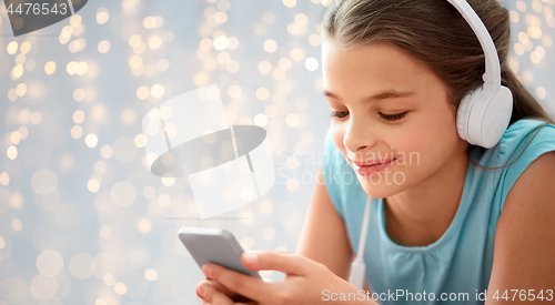 Image of close up of girl with smartphone and headphones