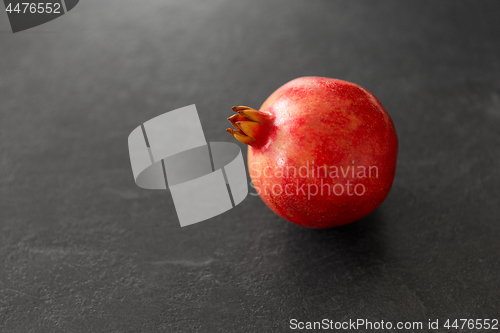 Image of close up of pomegranate on stone table