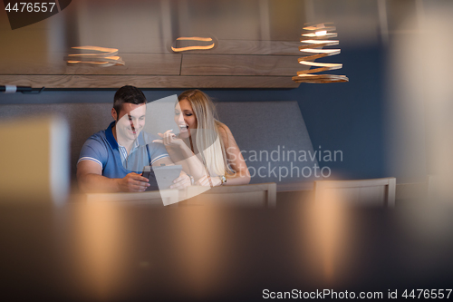 Image of couple using tablet at home