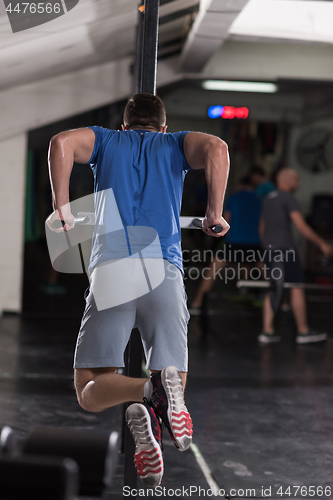 Image of man doing exercises parallel bars