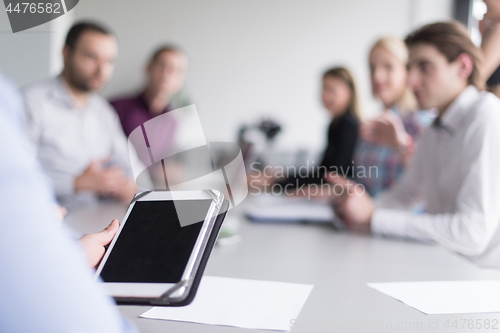 Image of Businessman using tablet in modern office