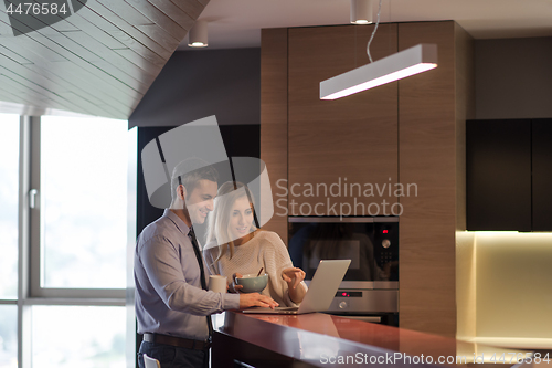 Image of A young couple is preparing for a job and using a laptop