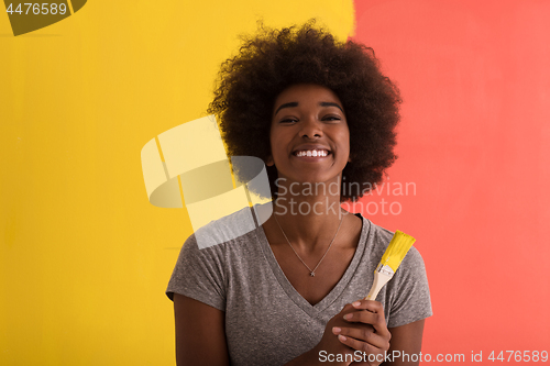 Image of black woman painting wall