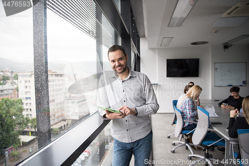 Image of Businessman Using Tablet In Office Building by window