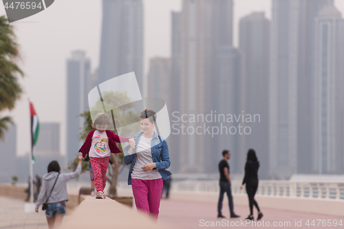 Image of mother and cute little girl on the promenade