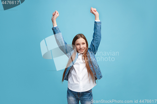 Image of Happy success teen girl celebrating being a winner. Dynamic energetic image of female model