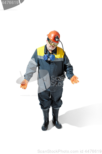 Image of The studio shot of senior bearded male miner standing at the camera on a white background.